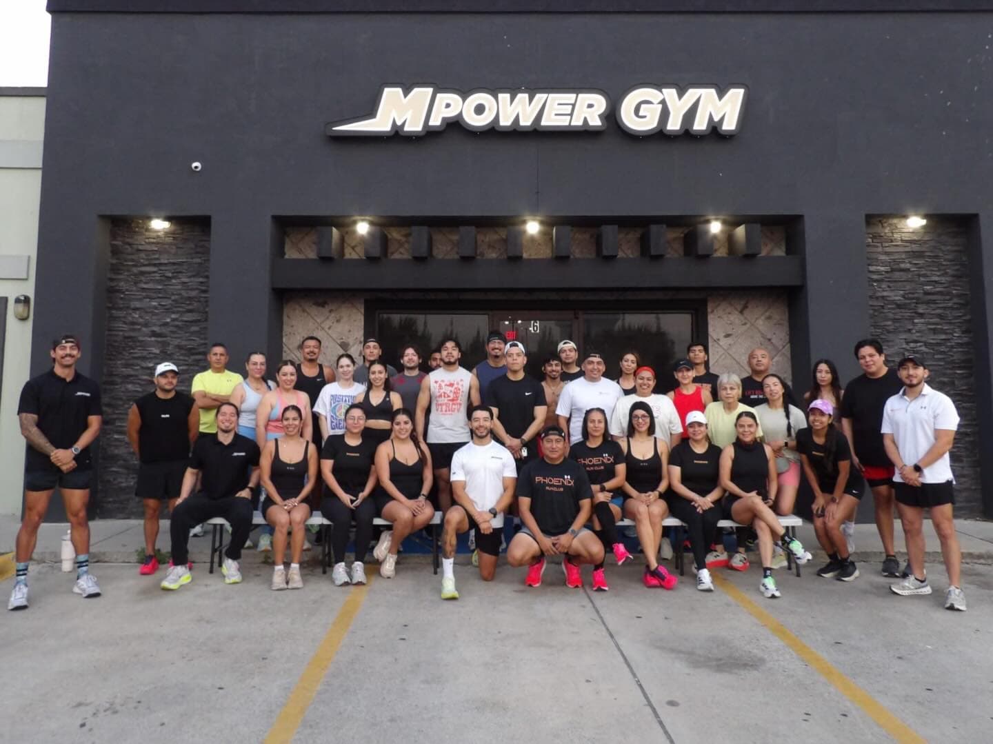 Dozens of members lined up in front of the Mpower Gym storefront at dusk