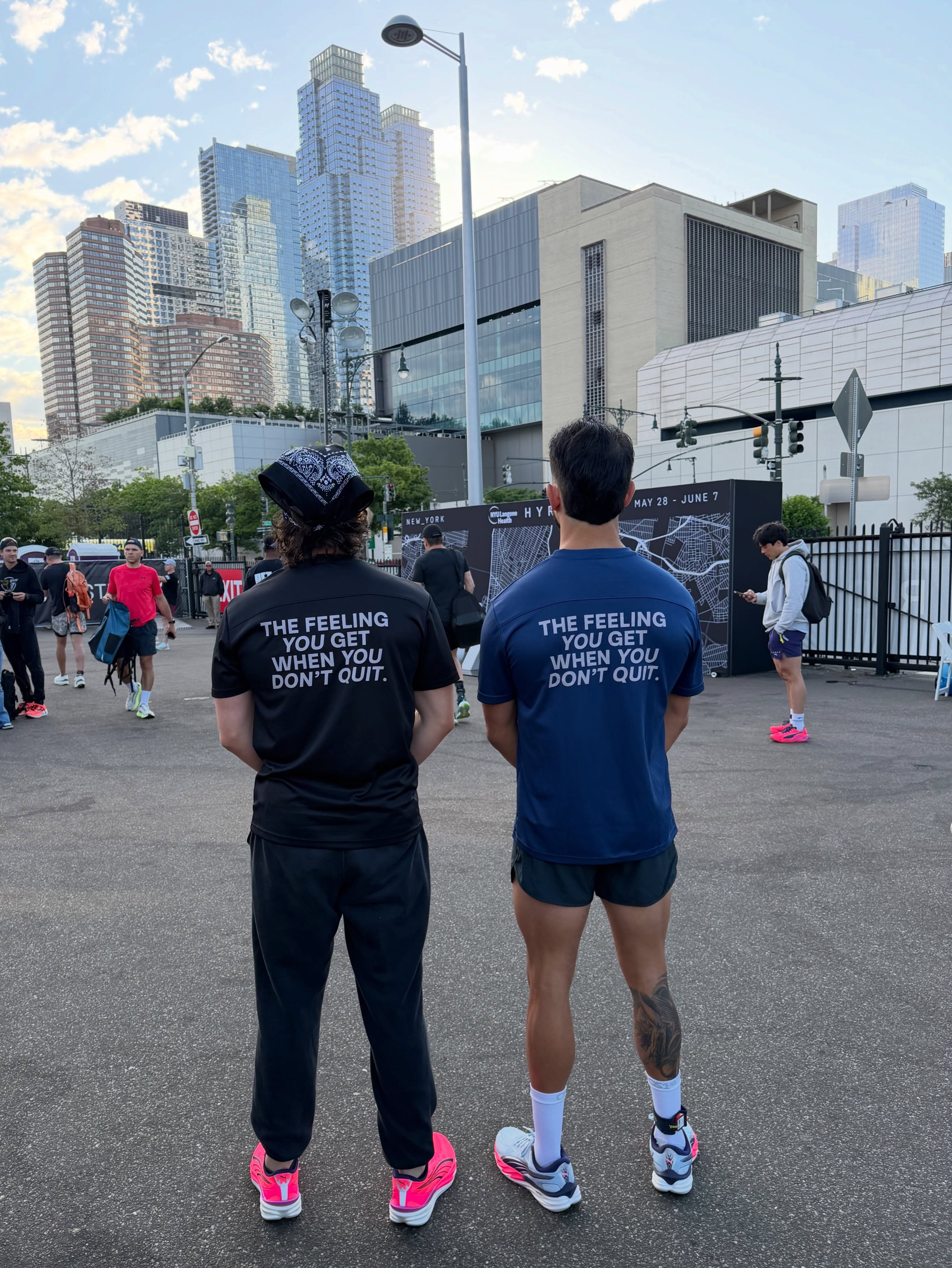 Two members in club shirts reading the feeling you get when you don't quit