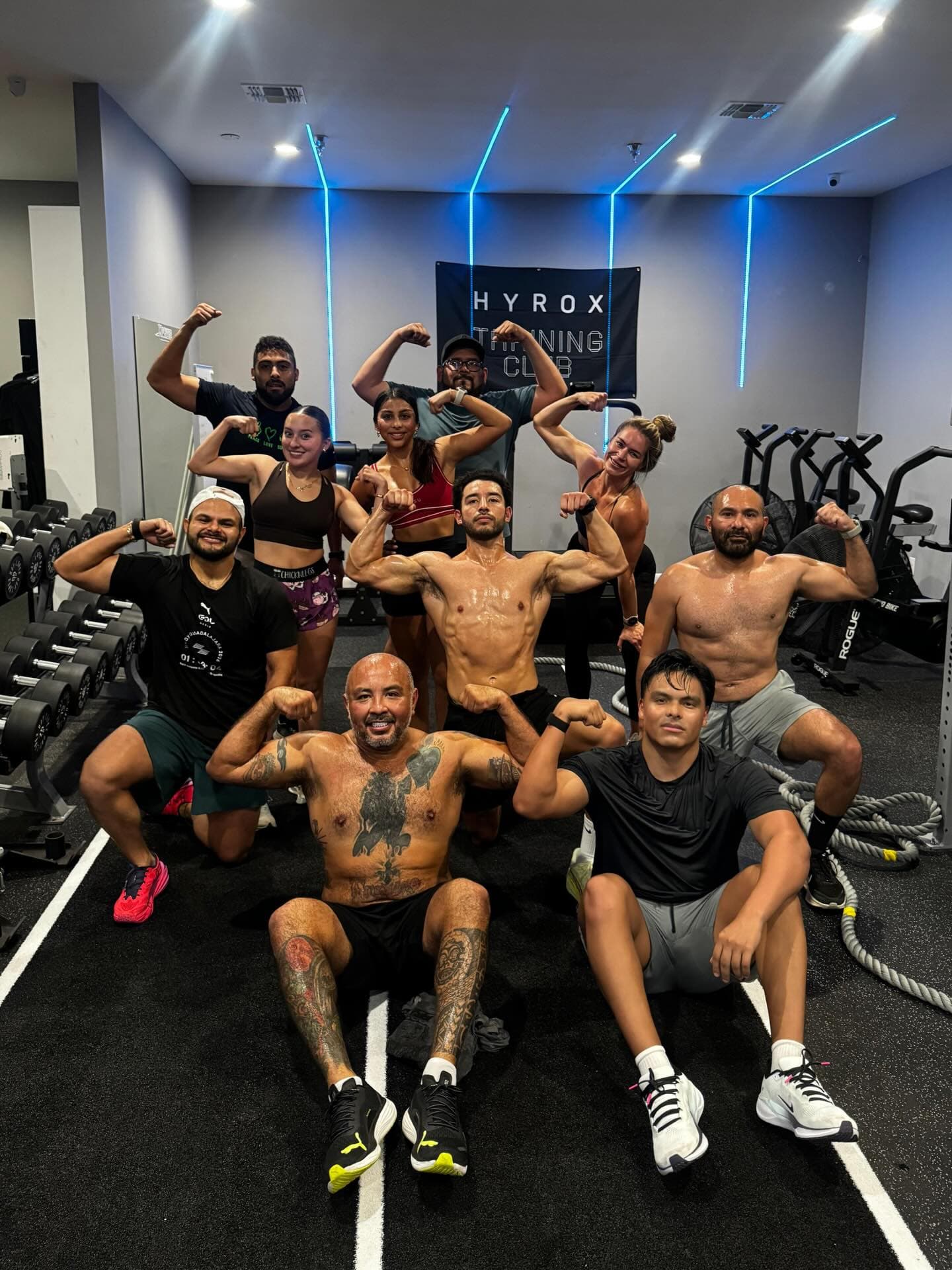 A semi private class posing together under the HYROX Training Club banner